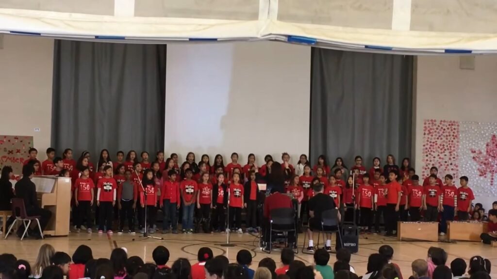 Students in red outfits attending a school convention at McKee Public School